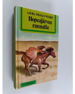 Kirjailijan Laura Ingalls Wilder käytetty kirja Hopeajärven rannalla