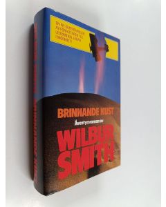 Kirjailijan Wilbur Smith käytetty kirja Brinnande kust
