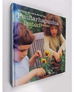 Kirjailijan Catherine Woram käytetty kirja Puutarhapuuhia lasten kanssa
