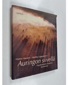 Kirjailijan Hannu Hautala & Markku Lappalainen käytetty kirja Auringon siivellä : Vuodenkierto Suomen luonnossa
