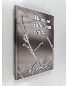 Kirjailijan Unto Matinlompolo käytetty kirja Maan ja taihvaan välilä