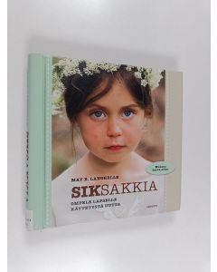 Kirjailijan May B. Langhelle käytetty teos Siksakkia : ompele lapselle käytetystä uutta