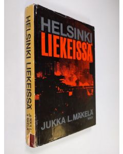 Kirjailijan Jukka L. Mäkelä käytetty kirja Helsinki liekeissä : Suurpommitukset helmikuussa 1944