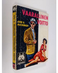 Kirjailijan John D. McDonald käytetty kirja Vaarallinen voitto