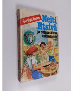 Kirjailijan Carolyn Keene käytetty kirja Neiti Etsivä ja salaperäinen kultanaamio