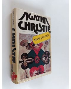Kirjailijan Agatha Christie käytetty kirja Kortit pöydällä / Syyttävä sormi