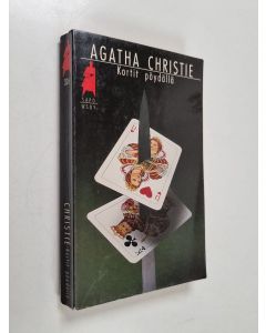 Kirjailijan Agatha Christie käytetty kirja Kortit pöydällä