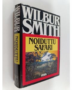 Kirjailijan Wilbur Smith käytetty kirja Noiduttu safari