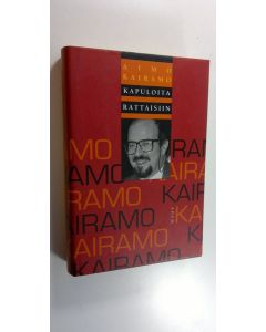 Kirjailijan Aimo Kairamo käytetty kirja Kapuloita rattaisiin : kolumnistin valittuja kirjoituksia (ERINOMAINEN)