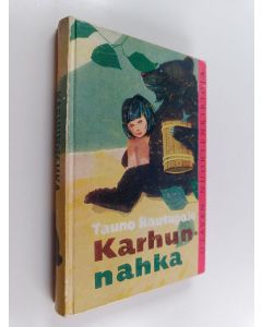 Kirjailijan Tauno Rautapalo käytetty kirja Karhunnahka : merkillinen tarina pohjoisesta