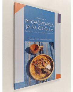 Kirjailijan Merja Isotalo käytetty kirja Pitopöydässä ja nuotiolla - suomalaisen ruokakulttuurin opinto-opas